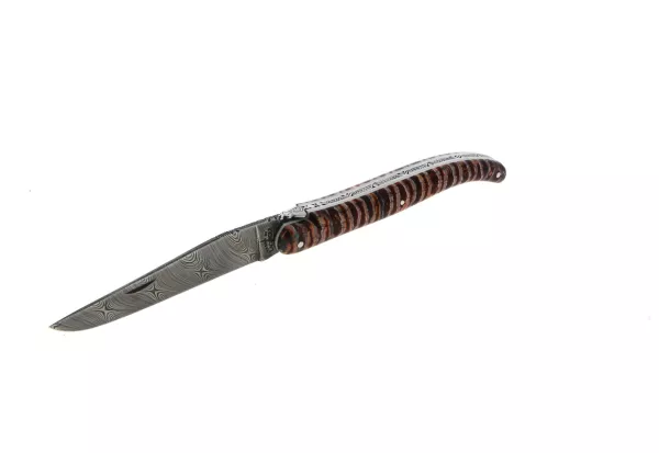 Custom folding knife in red mammoth molar with twist Damascus blade